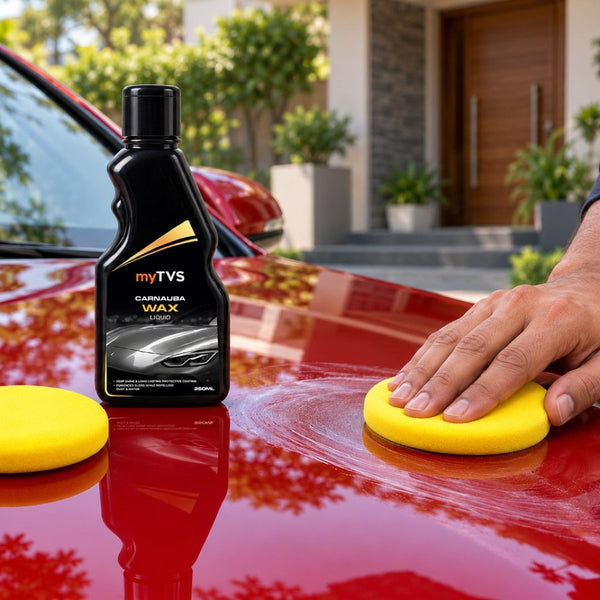 Yellow foam applicator pads spreading myTVS Carnauba Wax on a red car