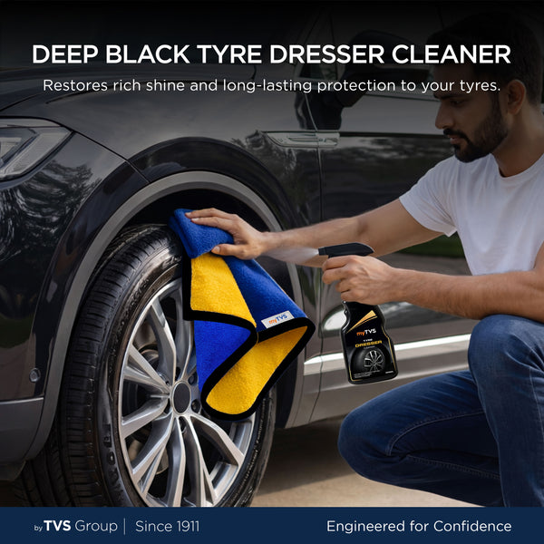 myTVS Deep Black Tyre Dresser Cleaner spray being used with a microfiber cloth to clean and shine a car tyre