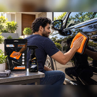 Man buffing a black car door with the myTVS 800 GSM microfiber cloth